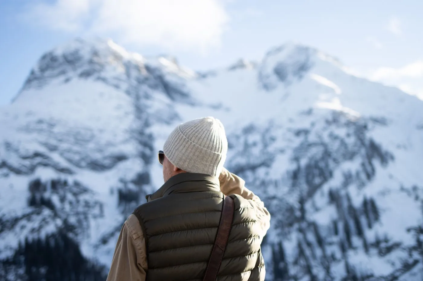 An olive quilted vest in the snow, standing in for the Gobi Heat Dune Heated Vest
