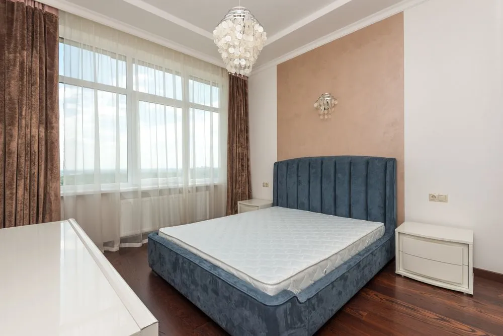 A bare quilted mattress top, standing in for a heated mattress pad