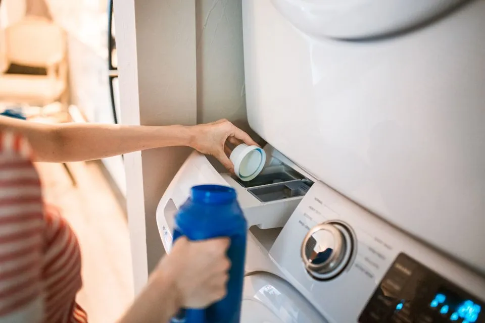 Mild detergent being added to a front-loading washer's dispenser